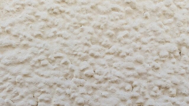 Off-white textured plaster wall surface background