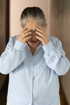 Stressful and depressed asian senior old woman doing facepalm gesture