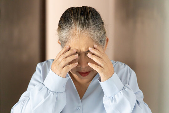 Stressful and depressed asian senior old woman doing facepalm gesture