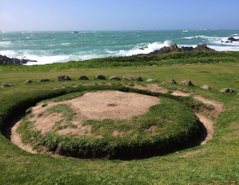 A wide-angle, eye-level shot of La Table des Pions, a well-known landmark and ancient monument popularly called the Fairy Ring, located at Pleinmont Point in Guernsey.