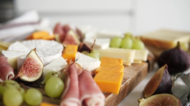 Cheese Board With Fruits And Ham On A Table As Charcuterie Board