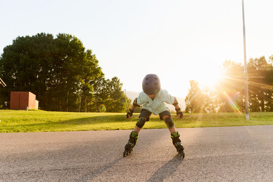 Young Boy Practicing Roller Skating at Sunset