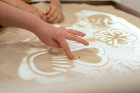Art therapy for children. Sand animation and sand painting