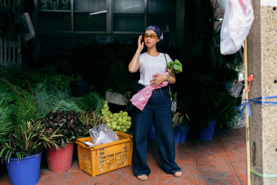 Young Woman Shopping At Flower Market Stall