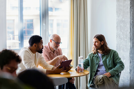 Colleagues Having a Casual Meeting and Discussion Over Coffee