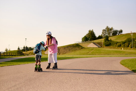 Mother Helping Son Learn Roller Skating