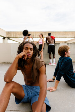Friends resting together in a park after a morning run