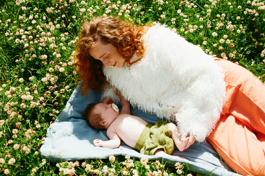 Mother and baby resting in a field of flowers