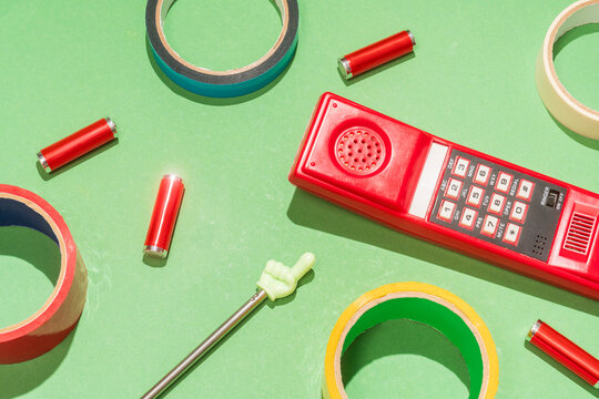 Retro red telephone with colorful office supplies
