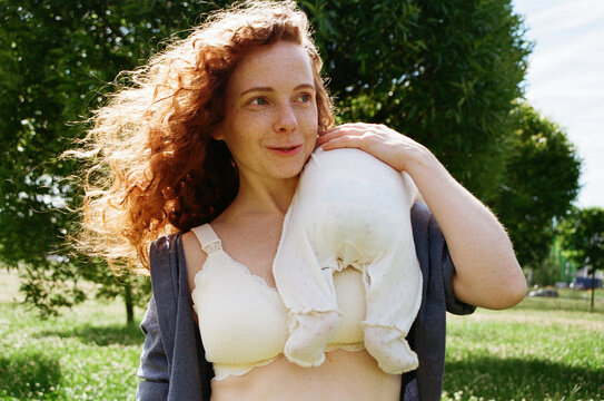 Woman with baby outdoors in a sunny park