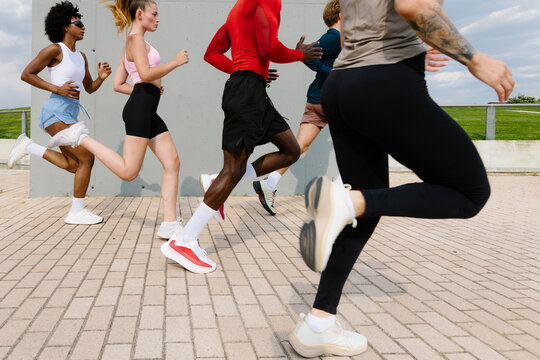 Active friends enjoy a sunny day outdoors, running together