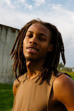 Close-up of a relaxed athletic Black man in a sunny morning park