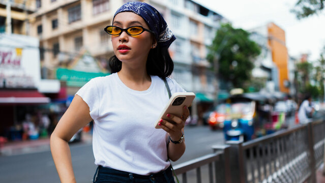 Young Woman Using Phone on Urban Street in City