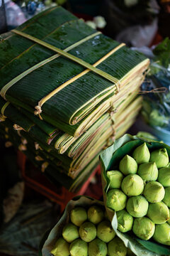 Banana Leaf Parcels and Lotus Buds at Market