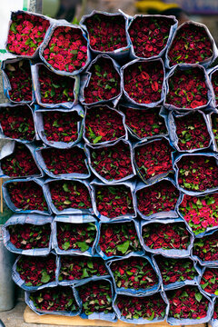 Stacked Red Rose Bouquets at Flower Market