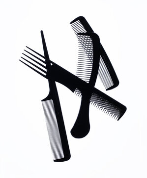 A group of black combs on a white background.