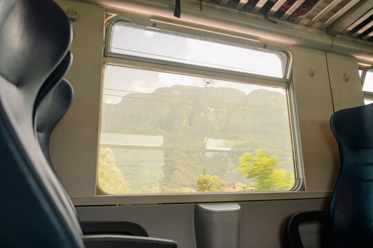 Empty train seats with mountain view through window