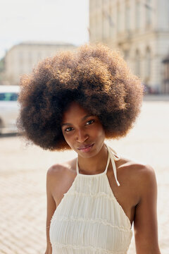 Woman With Natural Hair Standing in Urban Area During Daytime