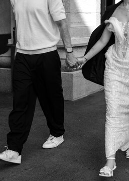 Bride and groom holding hands while walking together