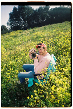 Man takes photo with camera in field
