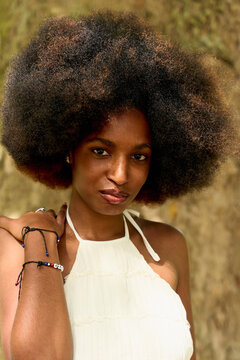 Woman Stands Outdoors With Natural Hair in Daylight