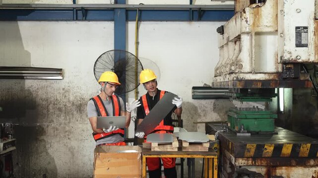 Quality sheet metal inspection runs at the bench where one technician reads the laptop and the other steadies the blank