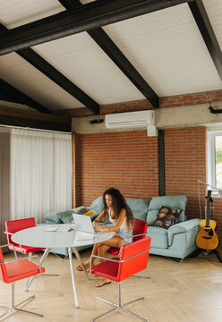 Woman Works On Laptop In Living Room