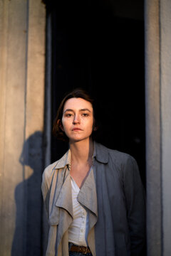 Woman Standing at the Door With Soft Light in the Background