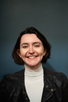 Portrait of a Woman Smiling Against a Blue Background