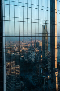 City Reflected in Glass Skyscraper Facade