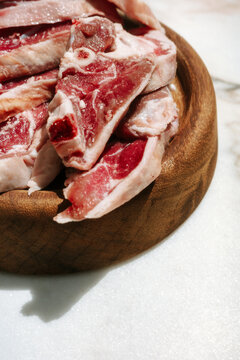 Fresh Cuts of Meat on a Wooden Board Ready for Cooking