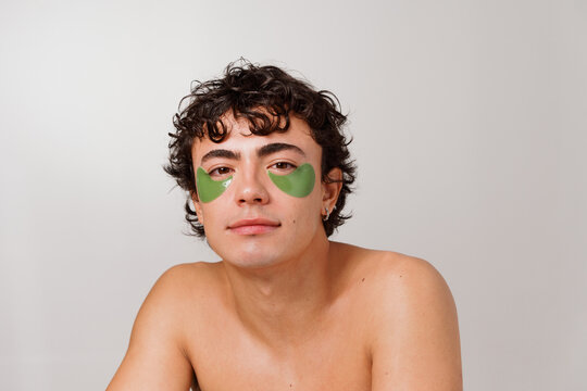 Man With Green Eye Patches at Home During Self-Care Routine