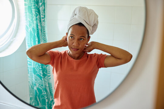 Woman finished washing her hair, holding a towel