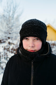 Winter's Chill Embraces a Youth in a Serene Snowy Landscape