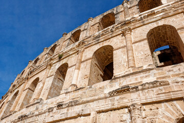 Obraz premium Symmetrical Architectural Detail of Ancient Roman Stone Arches and Columns at El Jem Amphitheatre