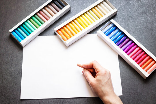 Set of soft pastel crayons in various shades in open white box, close up. Pastel crayons, set, shades, box, open, white, close up.

