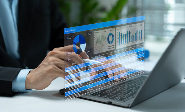 Financial analyst reviewing digital financial report on laptop with revenue, profit, ROI charts and business data dashboard for corporate finance, investment analysis and performance planning.