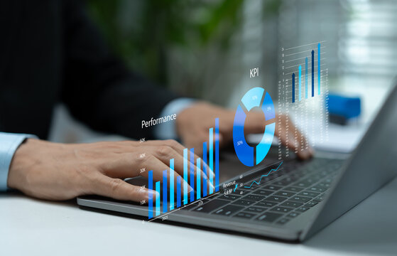 Businessman analyzing KPI dashboard on laptop with performance charts, revenue metrics and rising graphs, representing business growth, productivity tracking and strategic decisions.