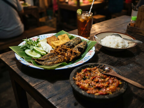 Traditional Indonesian Pecel Lele fried catfish with sambal and rice