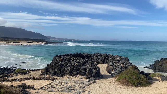 Typical stone wind break on the volcanic shore at Orzola, 
&Oacute;rzola, Canary Islands, Spain