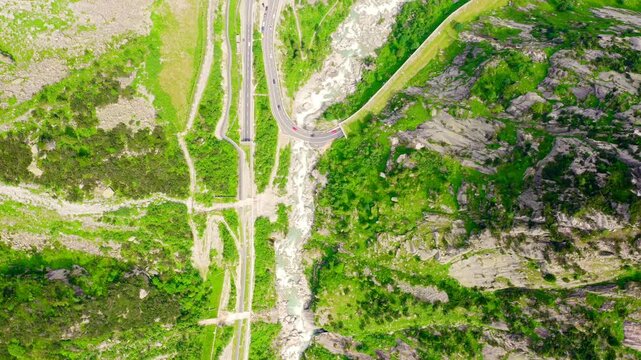 Switzerland. Picturesque winding mountain road with tunnels Gotthardstrasse. Drone footage, HEAD OVER SHOT