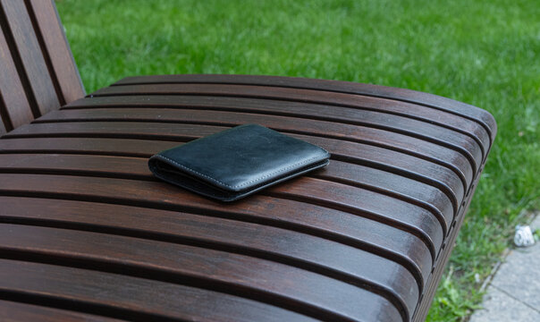The lost wallet on the street, forgotten black leather object