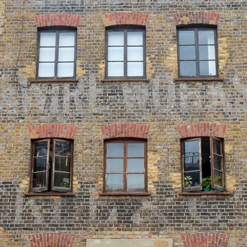 Old brick warehouse facade with faded ghost sign lettering