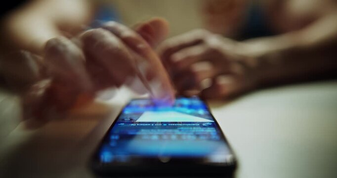 Doomscrolling. Close-up footage of a man's hand swiping through images on social media using a smartphone, featuring a creative multiple exposure effect and shallow depth of field. Modern digital life