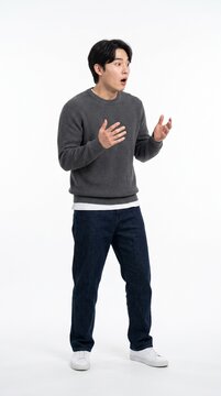 Young man with wide eyes and open mouth expressing shock and surprise, white background