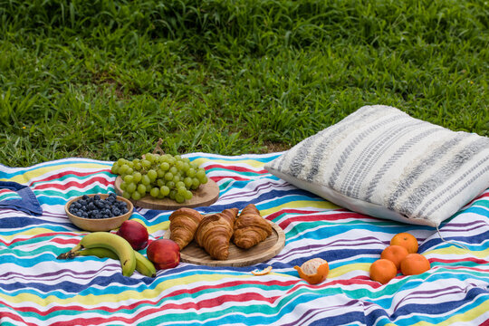 Close up of food and drinks during picnic in a summer day.