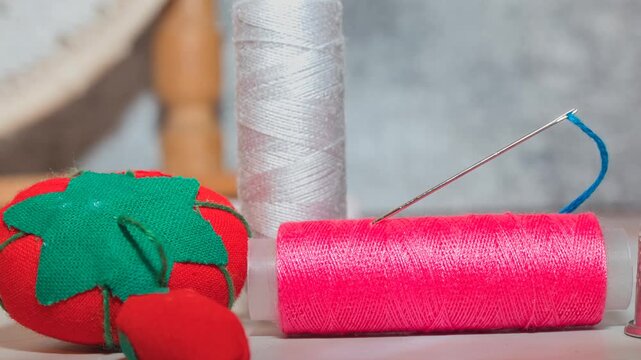 sewing tools: needle, bobbin, thread