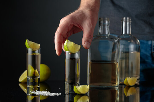 Gold tequila with sea salt and lime slices.