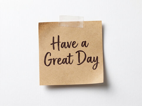 Taped note with handwritten text on a white surface