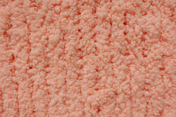 Soft peach sherpa fleece fabric texture close up background © Iryna Miadzvedzeva
